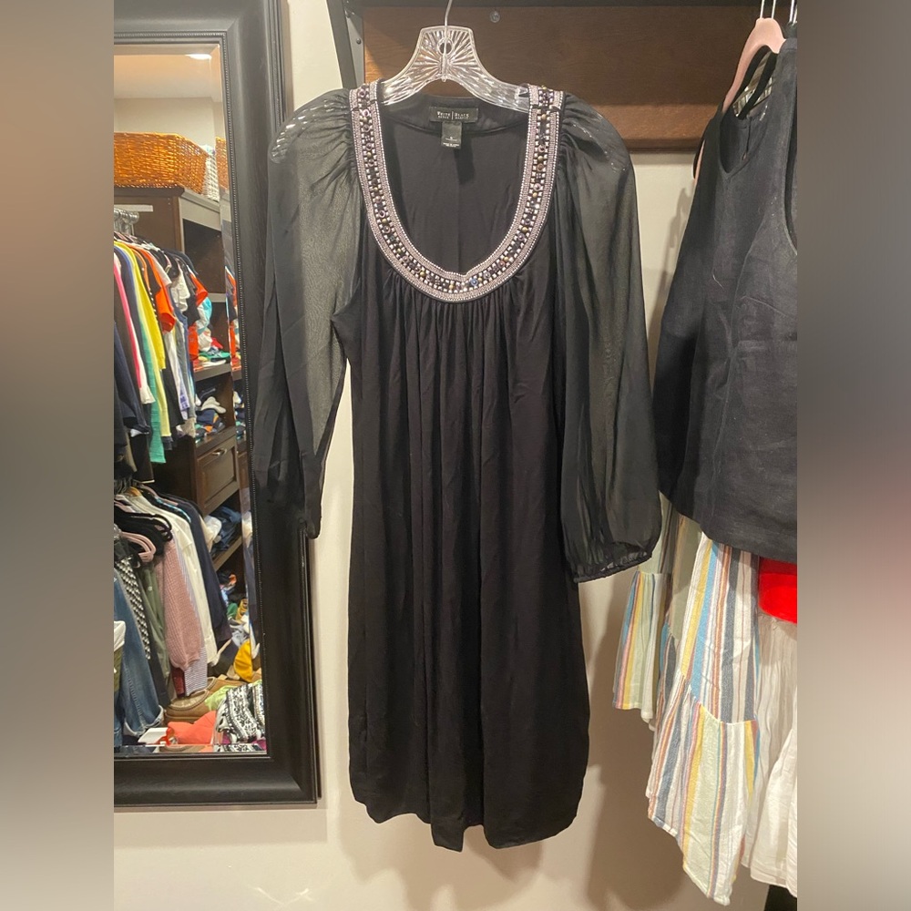 Black dress with sheer sleeves and embellishment at neckline